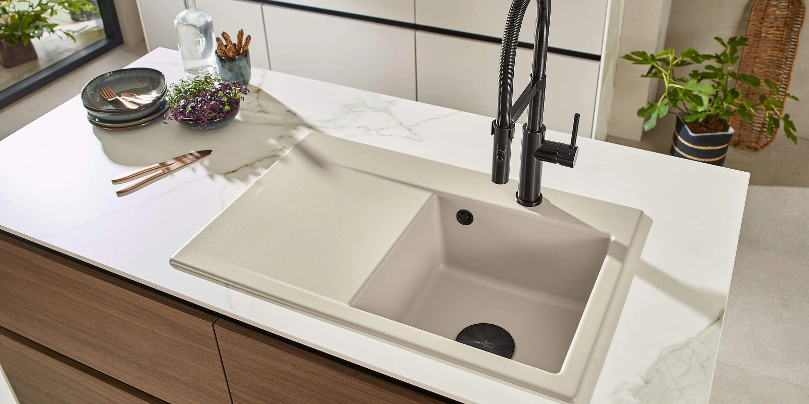 Foto: helles Villeroy & Boch Keramik-Waschbecken mit schwarzem Wasserhahn auf Marmor-Arbeitsplatte